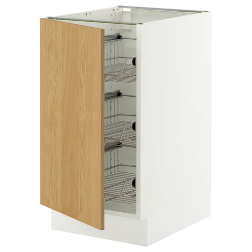 A white ikea SEKTION kitchen cabinet with a light oak door open, revealing wire shelves inside.