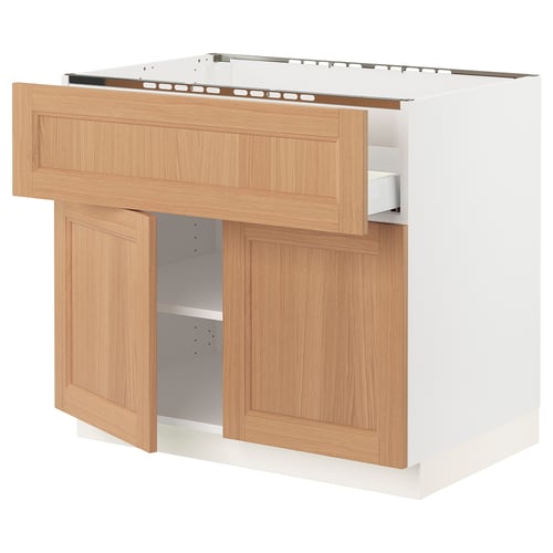A SEKTION kitchen unit in white with oak doors. The unit has open shelving and drawers.