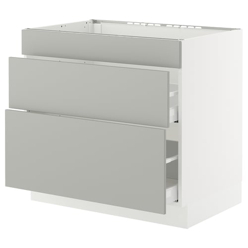 A white SEKTION kitchen cabinet with three light grey drawers. It a modern, clean design with sturdy construction.