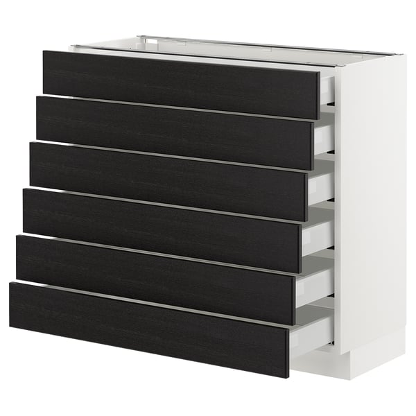 A white cabinet with black stained wooden drawers. It has six drawers with bevelled edges.