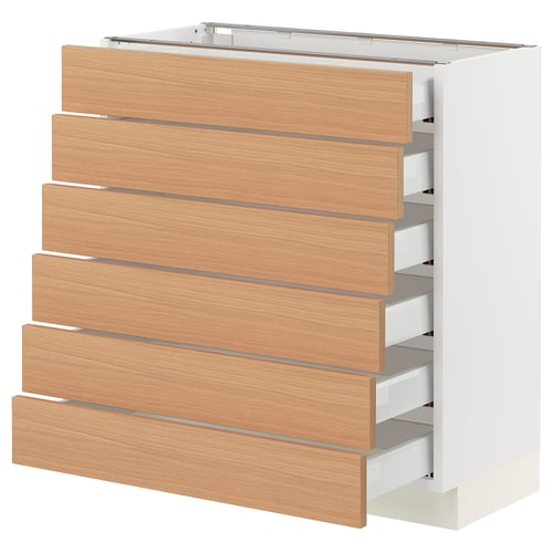 A light-colored SEKTION kitchen cabinet with wooden drawers. It six wooden drawers in a vertical line, and the cabinet is white.