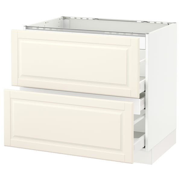 Off-white cream-colored kitchen cabinet with bevelled drawers.