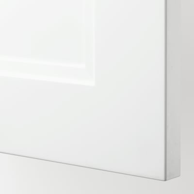 Closeup of white cabinet door, smooth and glossy surface, part of IKEAs SEKTION kitchen system.
