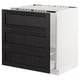 Black stained wood kitchen cabinet with bevelled edges and white frame.