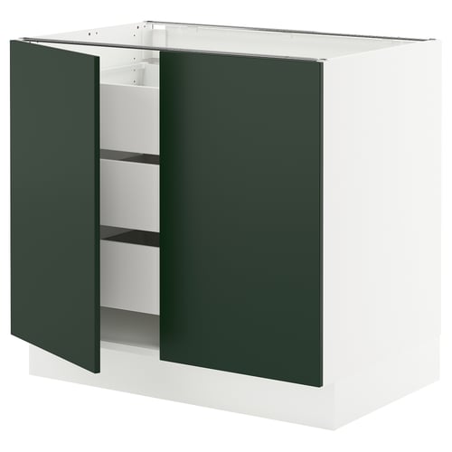 An open dark green ikea SEKTION kitchen cabinet with white interiors.
