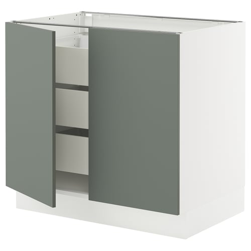 A white and green ikea SEKTION kitchen cabinet with two doors open, revealing shelves inside.