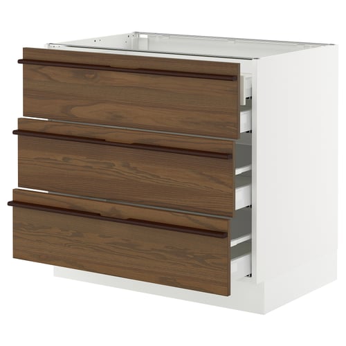 SEKTION kitchen unit in dark brown. Three wooden drawers with handles on a white cabinet. Modern and minimalist design.