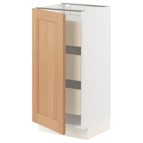 White kitchen cabinet with wooden door open showing shelves.
