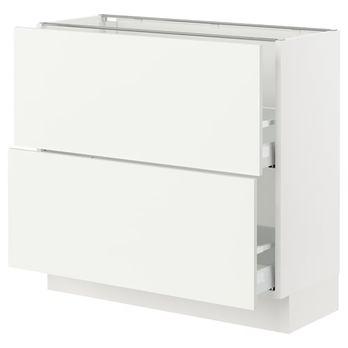 White kitchen cabinet, rectangular, with clean lines and modern design. Integrated drawers and smooth surfaces.