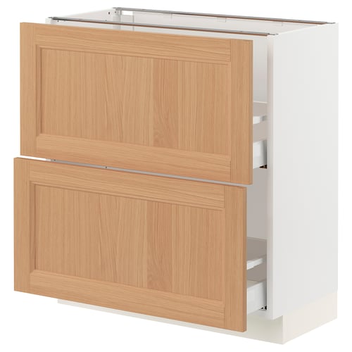 A SEKTION kitchen cabinet with oak fronts. Its rectangular, white with two wooden drawers. The design is modern and natural.