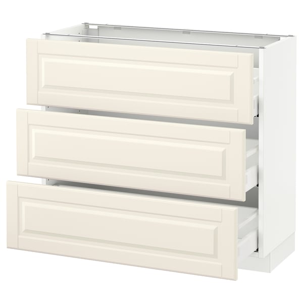 Depicts a white SEKTION kitchen cabinet with three open drawers and a flat top. The drawers have smooth, bevelled edges.