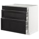 A white SEKTION base kitchen cabinet with three black stained wooden drawers. Each drawer has a bevelled edge, offering a traditional design.