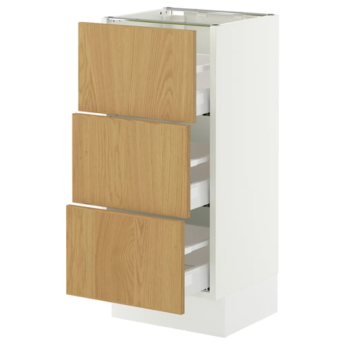 An ikea SEKTION white cabinet with three light wood drawers. The drawers have minimalist design and oak veneer finish.