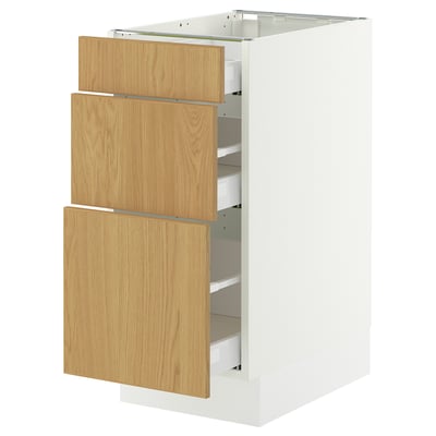 White SEKTION kitchen cabinet with oak drawers, three partially open