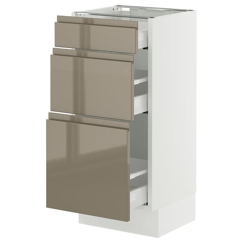 A modern, white SEKTION kitchen cabinet with three metallic gold drawers, featuring sleek, flush handles.