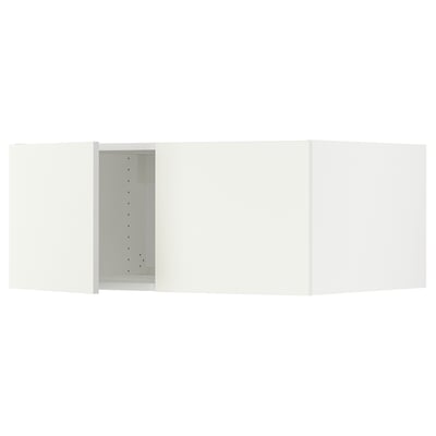 A white SEKTION kitchen cabinet with an open door, exposing adjustable shelves inside.