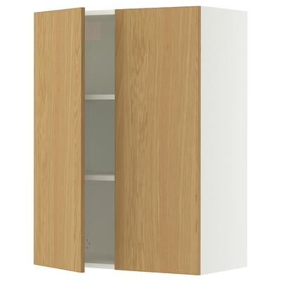 A white SEKTION wall cabinet with light oak doors and adjustable shelves, featuring a gentle door closer.