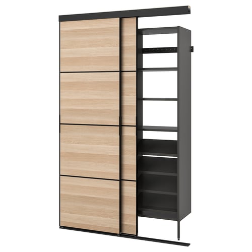 SKYTTA storage unit in light wood and black. Sliding doors, adjustable shelves. Modern, space-saving design.