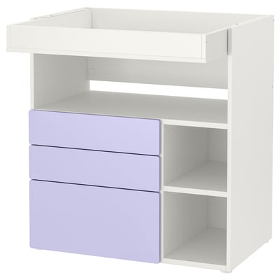 White changing table with 3 lavender drawers, open shelves.