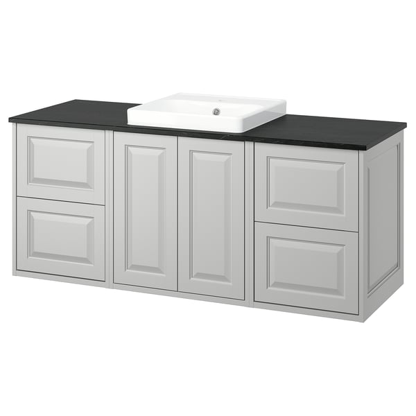 White TÄNNFORSEN bathroom vanity with black countertop and sink.