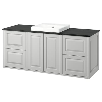 White TÄNNFORSEN bathroom vanity with black countertop and sink.