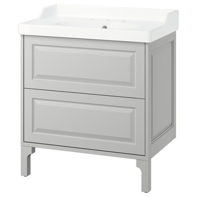 A white TÄNNFORSEN bathroom vanity with drawers and a ceramic basin. The design light grey bevelled panels and ample storage space.