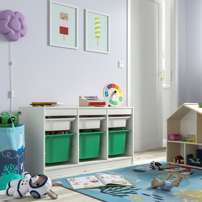Playroom with TROFAST storage, green bins. Organised, bright kids space.