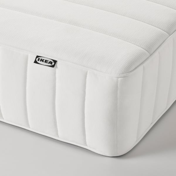 Close-up of IKEA VALEVÅG mattress showing firm, quilted surface and stitching.