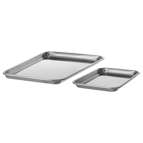 Two stainless steel baking trays, one larger, one smaller, both rectangular with raised edges, placed diagonally against a white background.