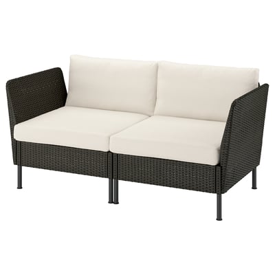 IKEA VITTSKÄR outdoor loveseat in dark grey with cream cushions, perfect for patio lounging.