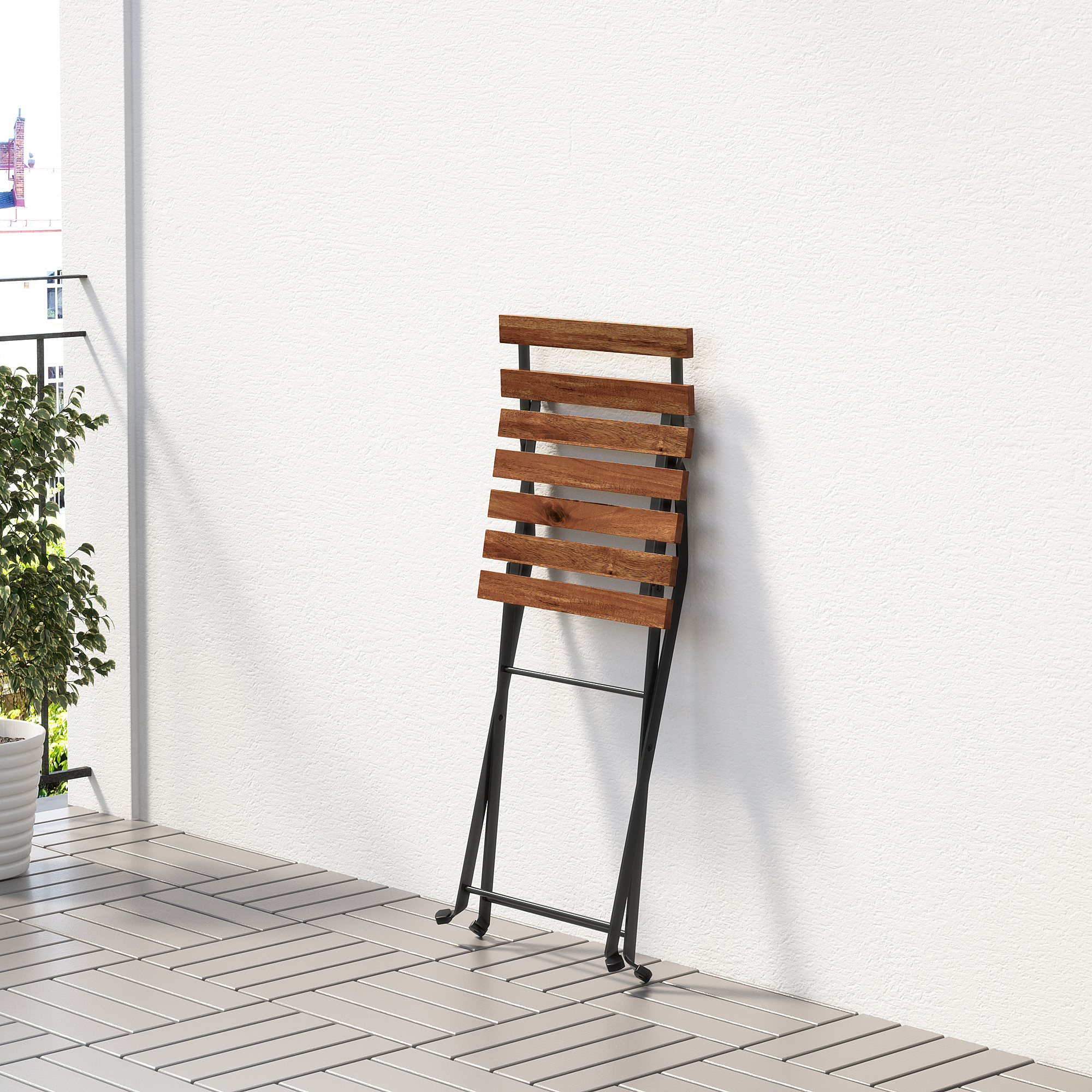 Single outdoor chair with wooden slat backrest and black frame.