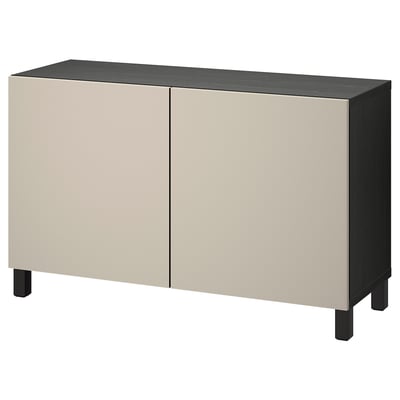 A beige and black BESTÅ sideboard with two doors. It has a rectangular shape with adjustable shelves inside. The legs are black, providing stability.