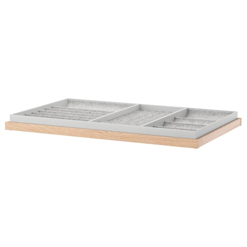 KOMPLEMENT: light wooden tray with grey compartments for accessories.