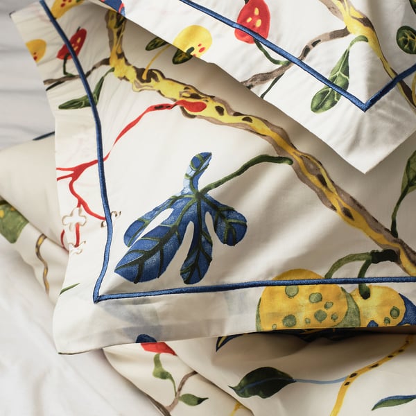 Luxurious duvet set with hand-drawn floral design, crisp cotton-lyocell blend, embroidered pillow border.