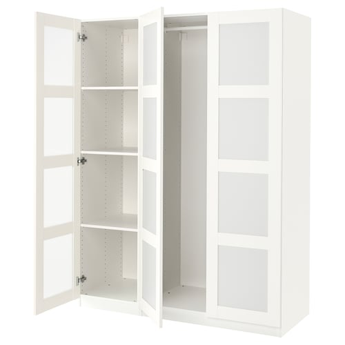 White PAX wardrobe, open doors revealing shelves. Modern, minimalist design.