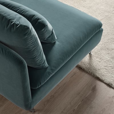 Teal SÖDERHAMN sofa on wooden floor with beige rug, showcasing plush cushions and stylish design.