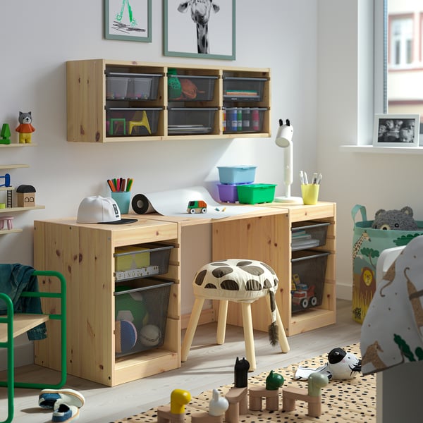 Childs room with wooden TROFAST storage units & toys. Light natural wood, colourful containers, and various kids’ items neatly arranged.