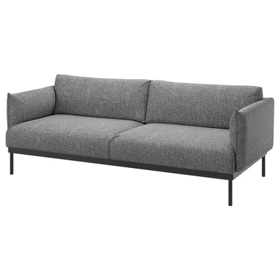 Moderní šedá látková pohovka, elegantní černé kovové nohy, čisté linie.