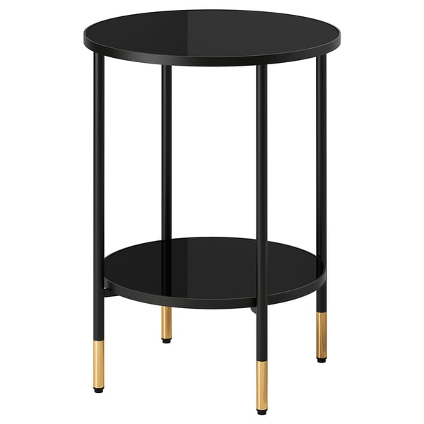 Elegantní černý odkládací stolek ÄSPERÖD s deskou z kouřového skla, zlatými akcenty a čtyřmi nohami pro moderní dekor.
