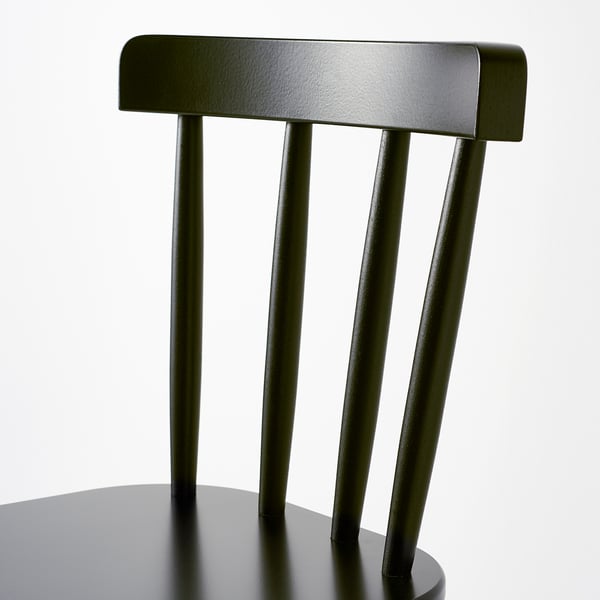 Tmavě zelené opěradlo židle se čtyřmi elegantními vertikálními lamelami. Jednoduchý, moderní design.