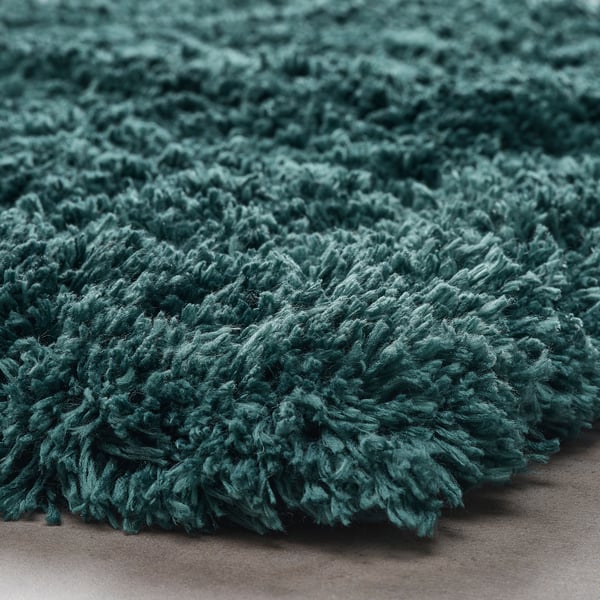 Měkká, plyšová modrozelená koupelnová předložka. Textura s hlubokým vlasem, recyklované materiály.