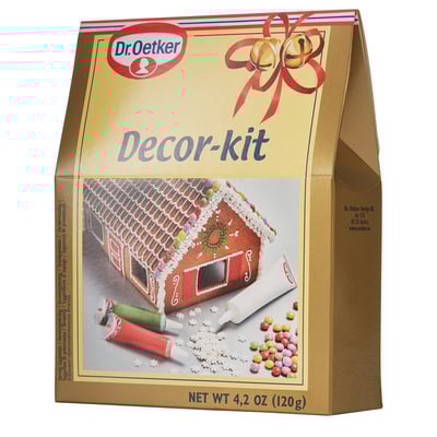 Krabička na dekorační sadu Dr. Oetker. Ukazuje perníkovou chaloupku, zkumavky, bonbóny. Používá se k pečení.