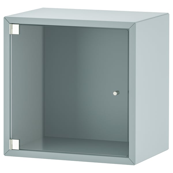 Ikea EKET světle modrý krychlový úložný díl se skleněnými dvířky.
