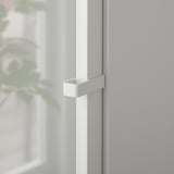 Detail moderního skleněného dveřního závěsu HÖGBO, elegantní bílá povrchová úprava, robustní kovová sestava.