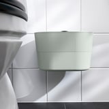 Moderní odpadkový koš s víkem, nástěnný, elegantní design. Visí na zeď pomocí lepicí pásky, udržuje prostor uklizený.