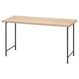 Psací stůl IKEA LAGKAPTEN s deskou ze světlého dřeva a černými kovovými nohami.