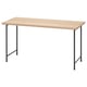 Psací stůl IKEA LAGKAPTEN s deskou ze světlého dřeva a černými kovovými nohami.