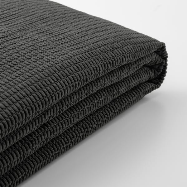 Detail měkké, texturované černé látky, složené. Vysoce kvalitní, recyklované materiály.
