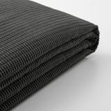 Detail měkké, texturované černé látky, složené. Vysoce kvalitní, recyklované materiály.