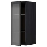 Moderní černá kuchyňská skříňka s jednoduchými dvířky z rákosového skla a elegantním kovovým rámem, stojící vzpřímeně s minimalistickým designem.